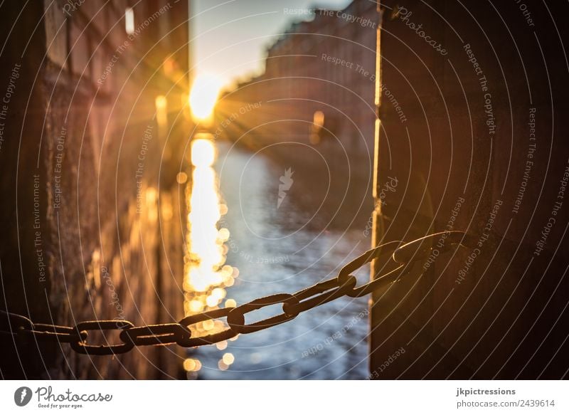 Chain at sunset in Speicherstadt Twilight Evening Sunset Light Romance Brick Old warehouse district Hamburg Germany World heritage Water Blue sky Cloudless sky