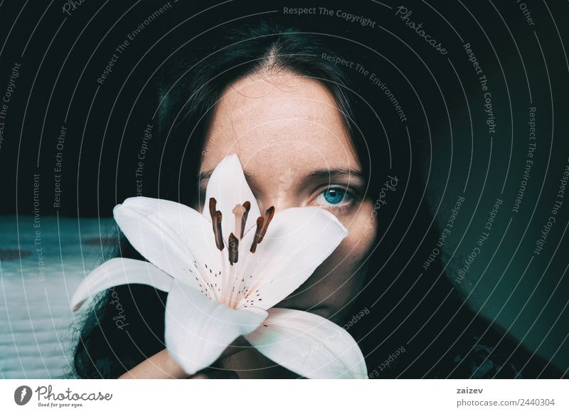 a girl with a white lily covering an eye Lifestyle Beautiful Face Relaxation Calm Human being Feminine Young woman Youth (Young adults) Woman Adults 1