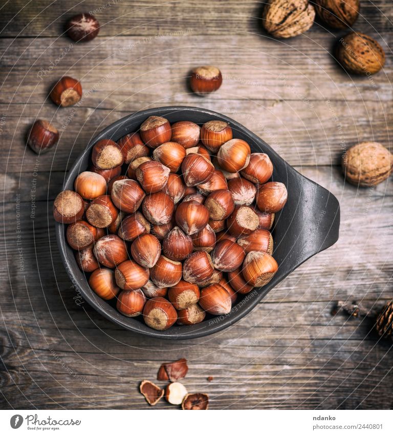 hazelnut in a shell Fruit Nutrition Vegetarian diet Bowl Wood Eating Fresh Natural Brown background Organic food many seed Nutshell Tasty Snack Ingredients Raw