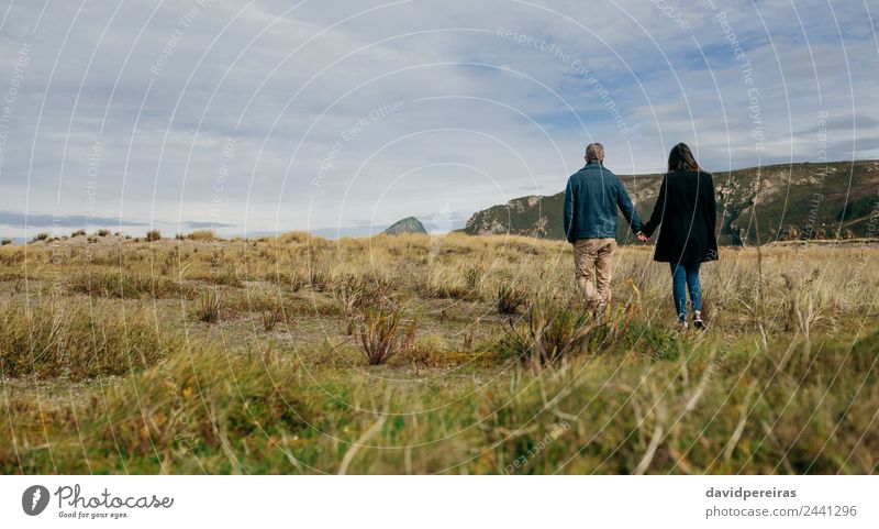 Unrecognizable couple walking near the coast Lifestyle Beautiful Calm Leisure and hobbies Vacation & Travel Winter Human being Woman Adults Man Couple Hand