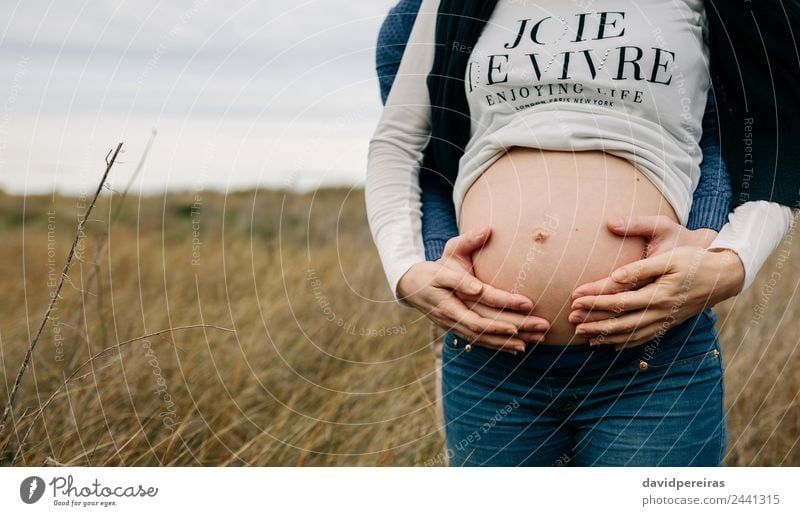 Pregnant with partner hugging and holding naked belly Lifestyle Beautiful Human being Woman Adults Man Mother Couple Hand Nature Landscape Grass Meadow Touch