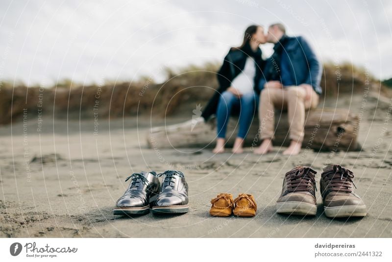 Family shoes in the sand with couple kissing Life Beach Winter Human being Baby Woman Adults Man Parents Mother Father Family & Relations Couple Feet Sand
