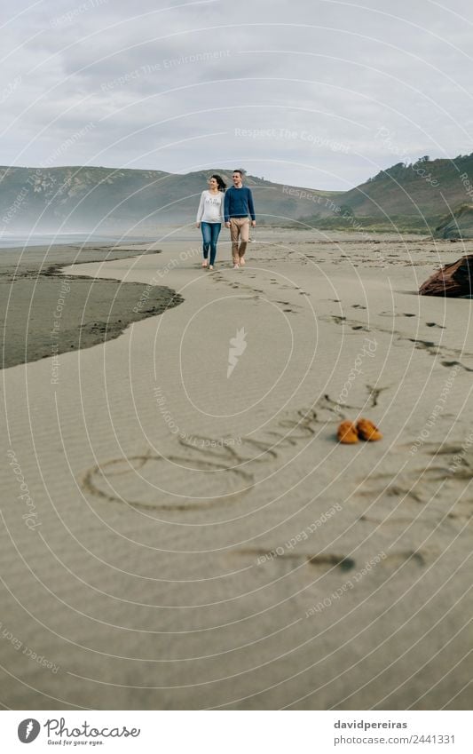 Parents walking with baby name Oliver written in the sand Lifestyle Beautiful Vacation & Travel Beach Ocean Waves Human being Baby Boy (child) Woman Adults Man