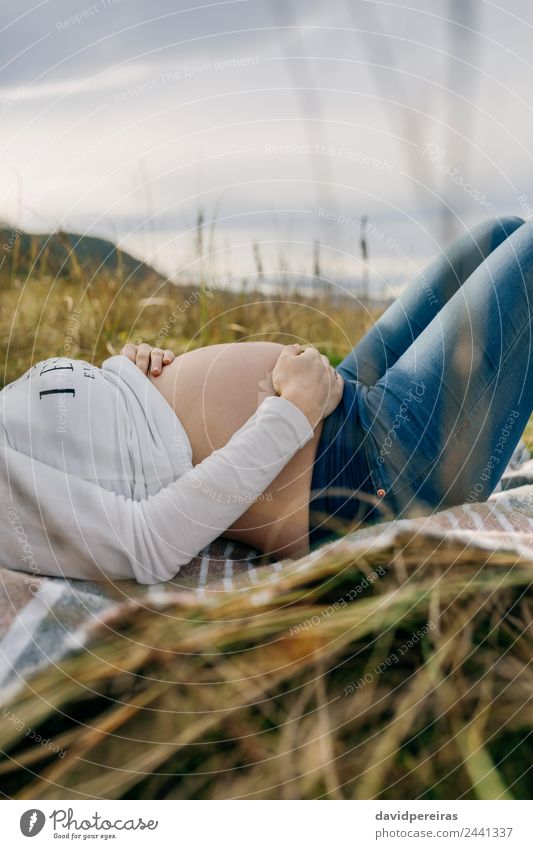 Pregnant woman caressing her tummy sleeping Lifestyle Beautiful Relaxation Human being Baby Woman Adults Mother Family & Relations Nature Landscape Grass Meadow