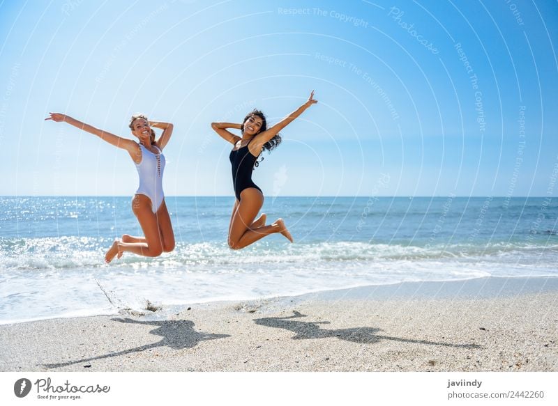 Two happy girls jumping on a tropical beach. Joy Vacation & Travel Tourism Summer Beach Ocean Human being Feminine Young woman Youth (Young adults) Woman Adults