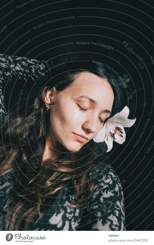 a girl with a white lily and closed eyes Lifestyle Beautiful Face Relaxation Calm Human being Feminine Young woman Youth (Young adults) Woman Adults 1