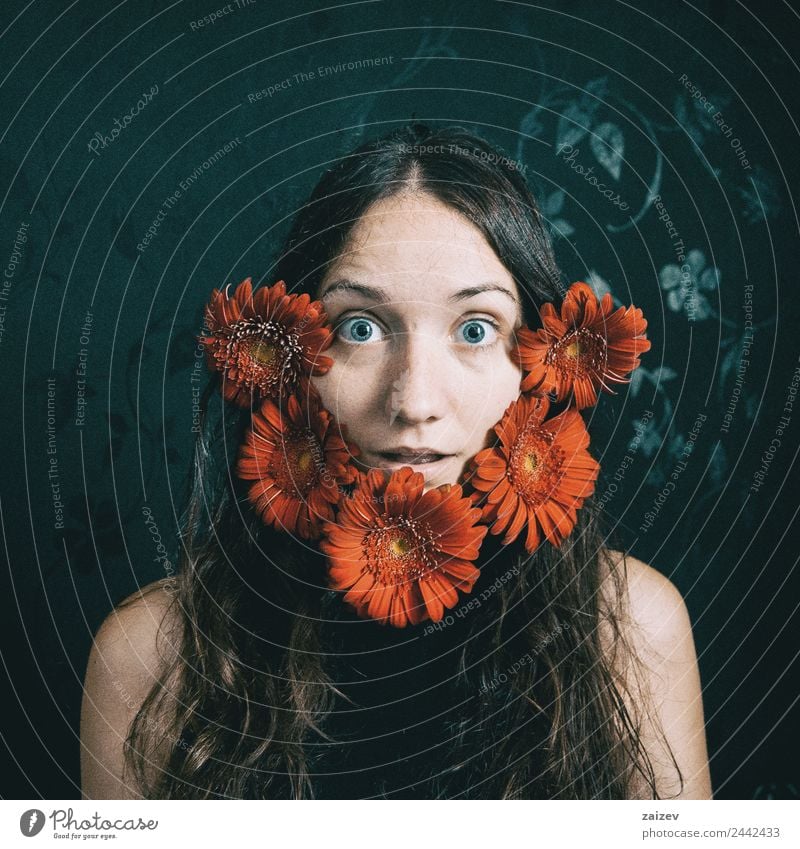 a girl with blue eyes and long hair with a beard of gerbera flowers Lifestyle Happy Beautiful Face Relaxation Human being Feminine Young woman