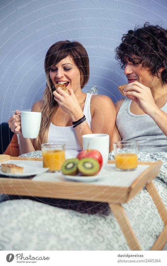 Couple having breakfast in bed served over tray Fruit Apple Breakfast Juice Coffee Lifestyle Happy Beautiful Relaxation Leisure and hobbies Bedroom Woman Adults