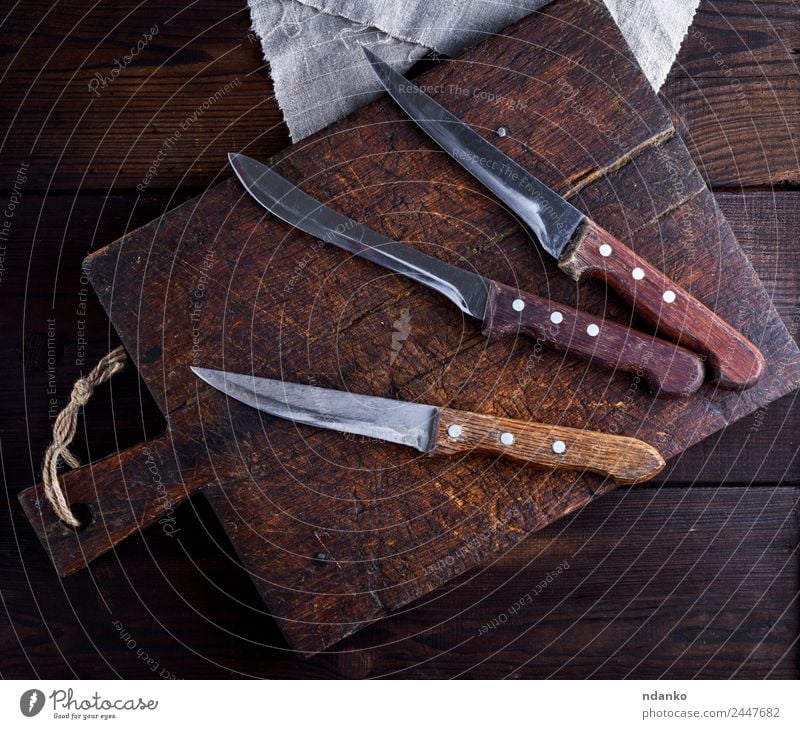 three old kitchen knives Knives Table Kitchen Tool Wood Metal Steel Old Brown knife background board food sharp blade Preparation Stainless Professional cooking
