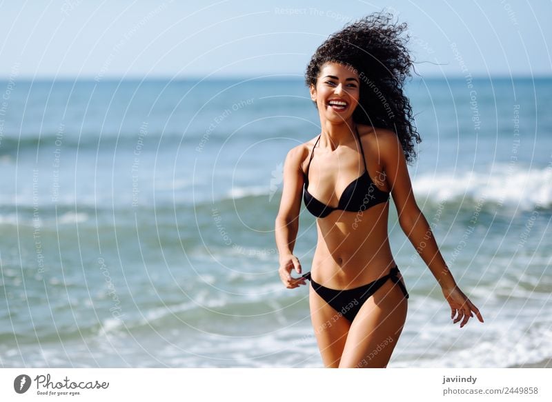 Young Woman in a Black Bikini on the Beach · Free Stock Photo