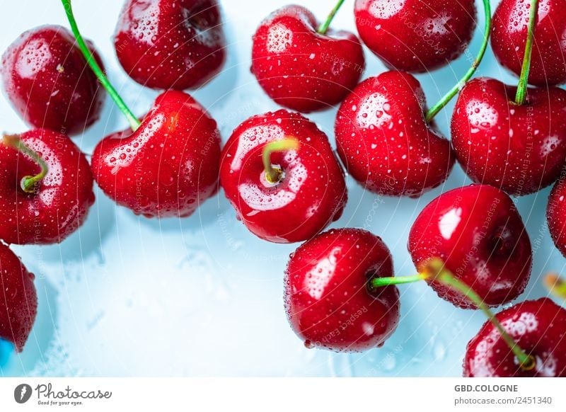 Fresh cherries with drops of water lying on a light-colored background Food Fruit Nutrition Organic produce Vegetarian diet Diet Healthy Healthy Eating