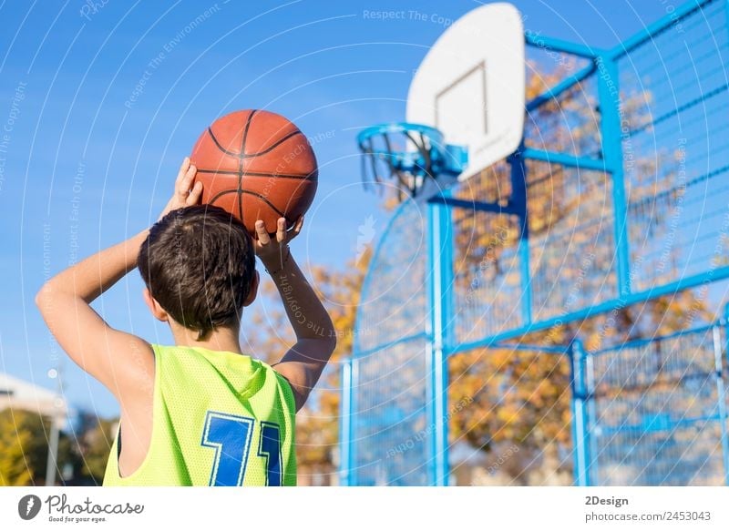 Young teenager male playing basketball on an outdoors court. Lifestyle Joy Athletic Relaxation Leisure and hobbies Playing Sports Human being Masculine