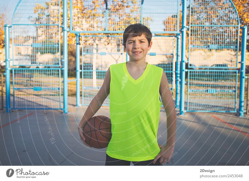 Teenage boy holding a basketball on a court Lifestyle Relaxation Playing Sports Ball Telephone PDA Human being Masculine Boy (child) Young man
