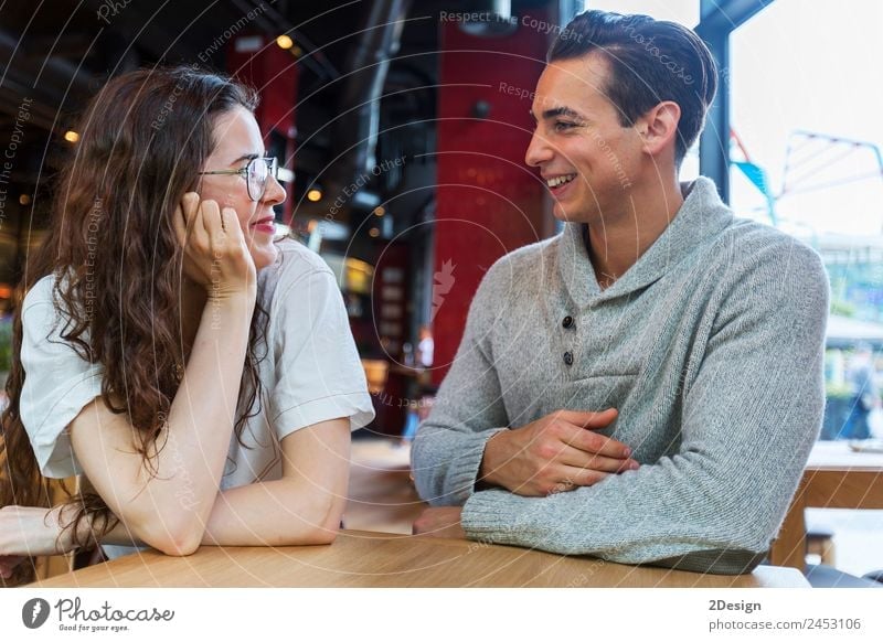 Side view of loving couple looking at each other sitting in a coffee shop Lunch Coffee Lifestyle Happy Beautiful Leisure and hobbies Table Restaurant Flirt