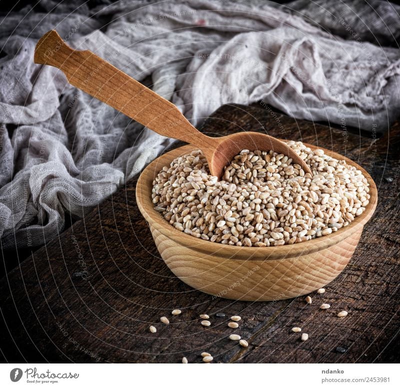 grain of wheat in a wooden bowl Bread Vegetarian diet Plate Bowl Spoon Table Wood Above Brown Yellow White Wheat background whole Cereal food healthy Rye seed