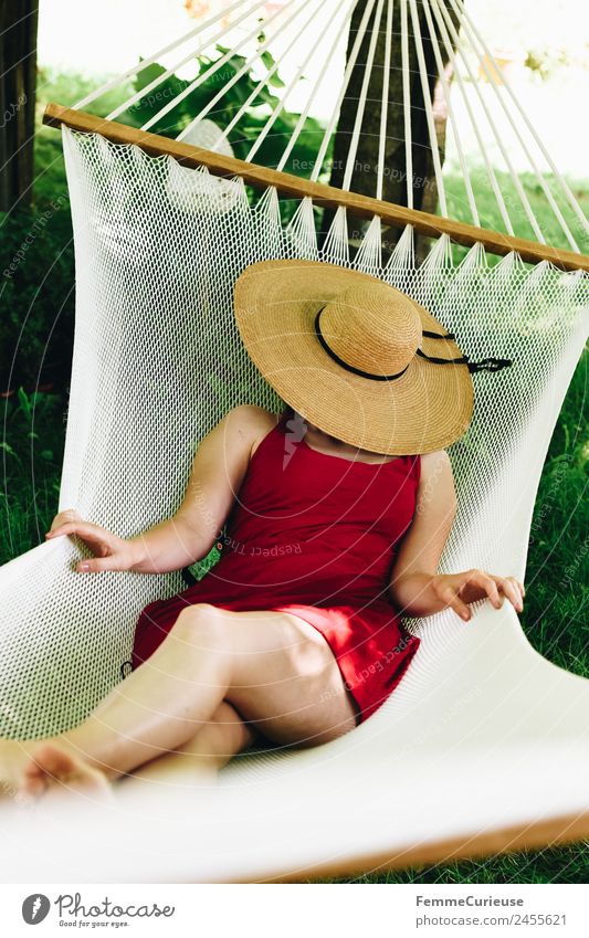 Young woman relaxing in a hammok Feminine Youth (Young adults) Woman Adults 1 Human being 18 - 30 years 30 - 45 years Relaxation Sunhat Hammock Garden Dress
