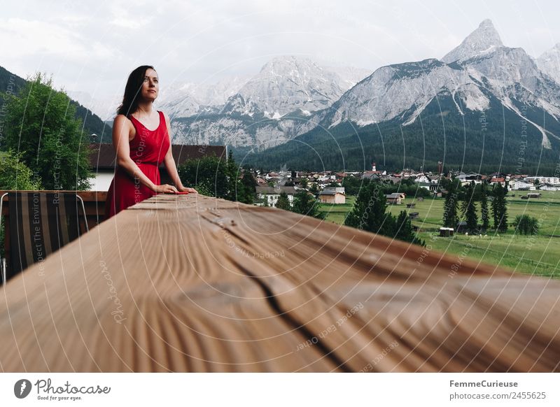 Young woman enjoying the view of the alps from a balcony Feminine Youth (Young adults) Woman Adults 1 Human being 18 - 30 years 30 - 45 years Relaxation Balcony