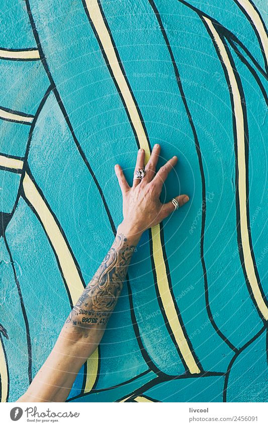 Tattooed arm on wall with graffiti Lifestyle Happy Beautiful Relaxation Calm Human being Feminine Woman Adults Arm Hand Fingers 1 45 - 60 years Art Painter