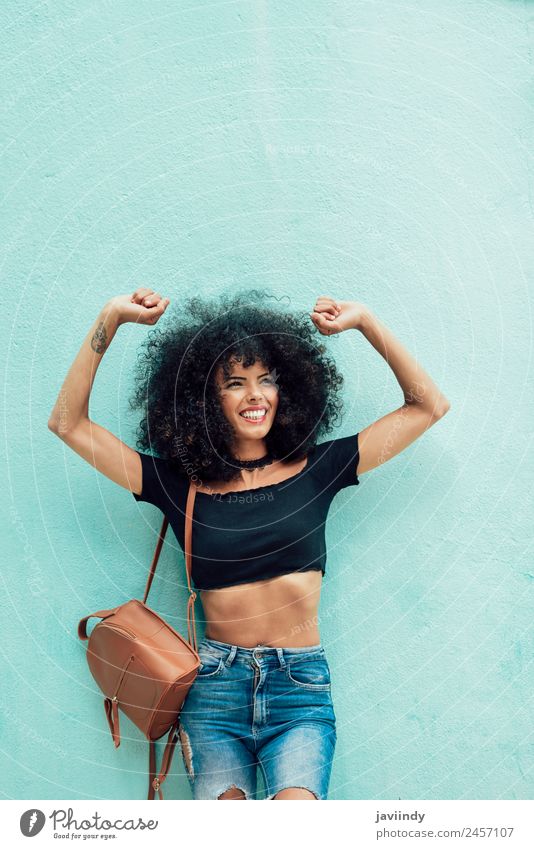 Smiling black woman with curly hair raising arms outdoors Joy Beautiful Hair and hairstyles Human being Young woman Youth (Young adults) Woman Adults Arm 1