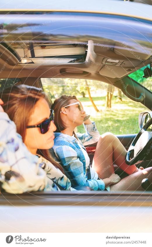 Two young women resting sitting inside of car Lifestyle Joy Happy Beautiful Relaxation Leisure and hobbies Vacation & Travel Trip Summer Sun Human being Woman