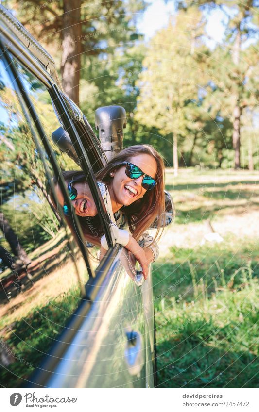 Happy young woman looking back through the window car Lifestyle Joy Beautiful Relaxation Leisure and hobbies Vacation & Travel Trip Summer Sun Human being Woman