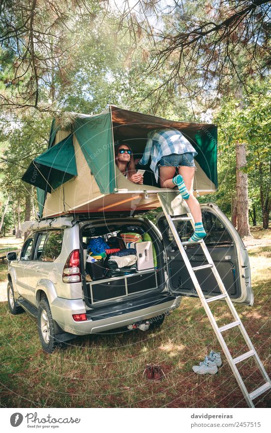 Woman walking up ladder to tent over car Lifestyle Joy Happy Leisure and hobbies Vacation & Travel Trip Camping Summer Hiking Climbing Mountaineering To talk