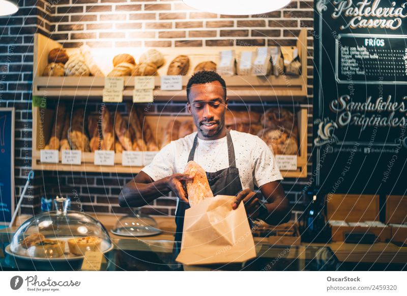 African man works in pastry shop. Bread Blackboard Work and employment Profession Business Human being Man Adults Smiling Stand Sell Happiness Bakery Storage