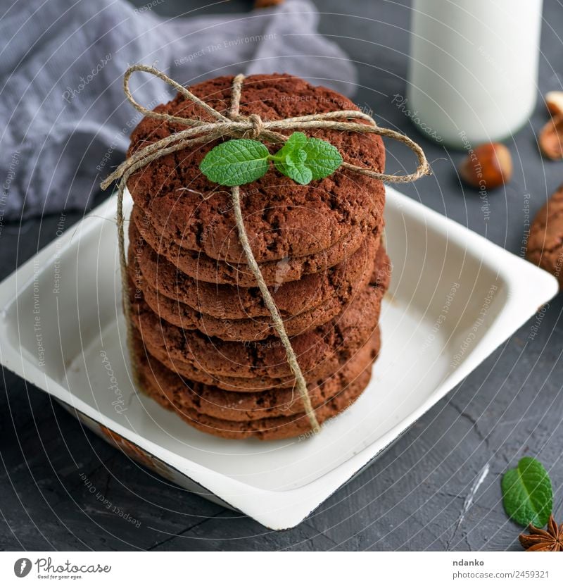 stack of round chocolate biscuits Dessert Candy Nutrition Plate Bowl Eating Delicious Above Brown White cookie milk background food Stack sweet Baking holiday