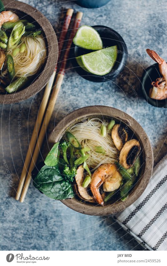 Bowl of Asian Noodle Soup with chopsticks Vegetable Stew Herbs and spices Lunch Dinner Table Pack Hot noodle Thai asian fish shrimp miso Mushroom lime healthy