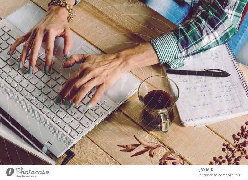 Woman writing on the computer, wearing plaid shirt and casual st Coffee Lifestyle Joy Leisure and hobbies Desk Table Education Adult Education Study