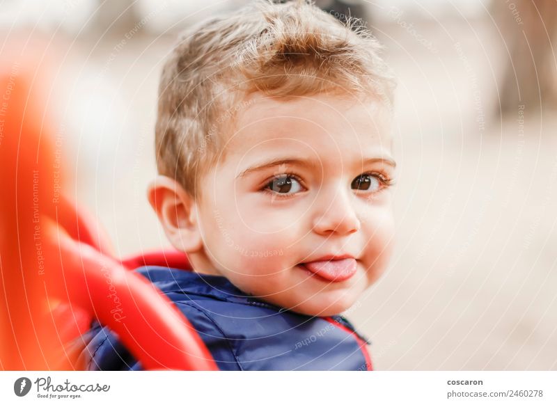 Little cute boy looking at camera and sticking out his tongue Joy Happy Face Child Baby Boy (child) Mouth Friendliness Funny New Cute Crazy Wild Blue Red White