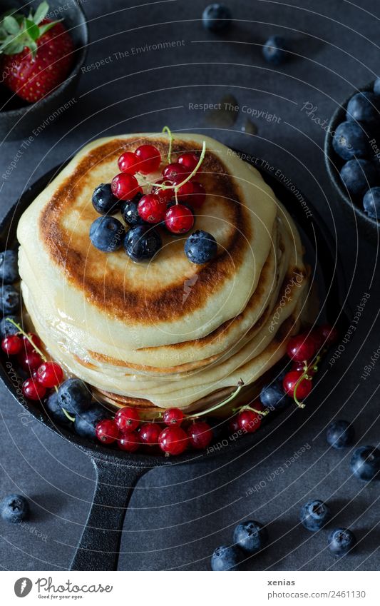 Small pancakes with blueberries and red currants in a cast iron pan Pancake Redcurrant Blueberry fruit Dough Baked goods Strawberry sugar syrup Breakfast Buffet