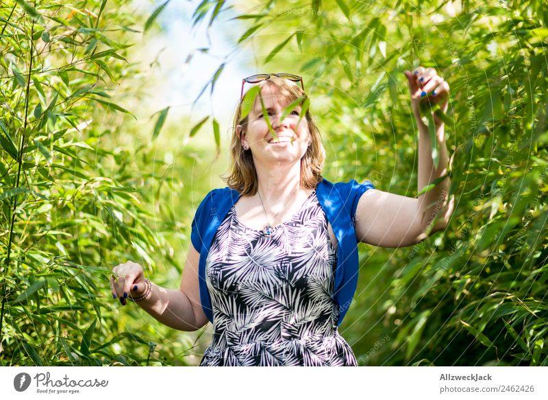 Portrait of a young woman in the bamboo jungle Portrait photograph Young woman 1 Person Woman Feminine Blonde Green Nature Day Bamboo Bushes Leaf Forest