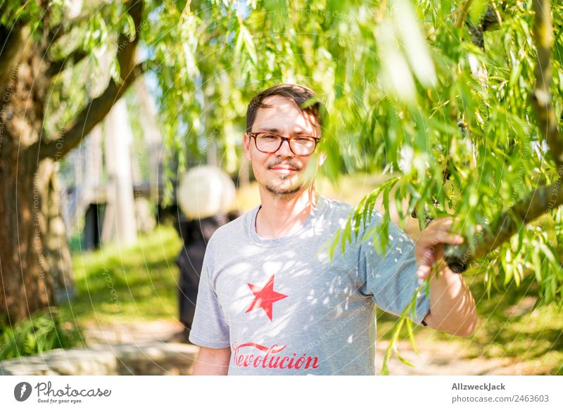 Portrait of a young man in nature Portrait photograph Young man 1 Person Eyeglasses Green Nature Day Sit Relaxation Break Restful To enjoy Park