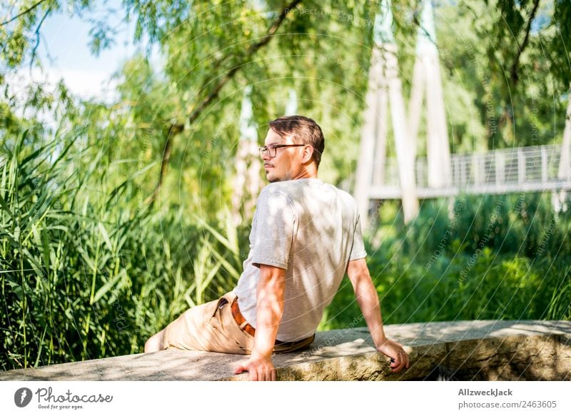 Portrait of a young man in nature Portrait photograph Young man 1 Person Eyeglasses Green Nature Day Sit Relaxation Break Restful To enjoy Park