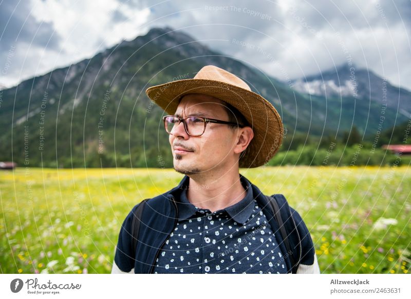 young man with hat in front of mountain panorama Day Beautiful weather Clouds Nature Green Tree Forest Mountain Idyll Vacation & Travel Travel photography