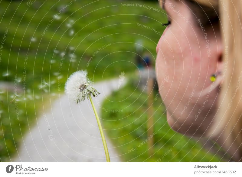 young woman blowing a dandelion Day Beautiful weather Nature Green Idyll Vacation & Travel Travel photography Hiking Germany Federal State of Tyrol Austria