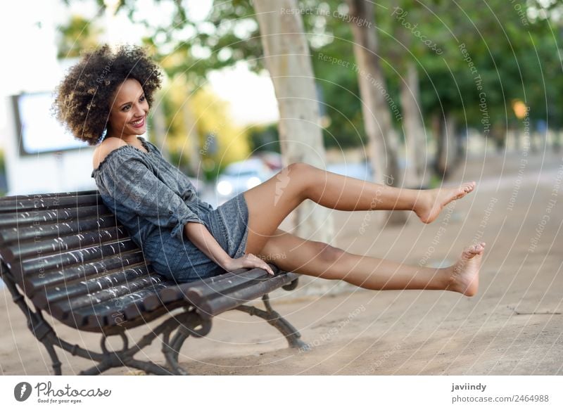 Young black woman with afro hairstyle sitting on a bench i Lifestyle Beautiful Hair and hairstyles Face Human being Feminine Young woman Youth (Young adults)