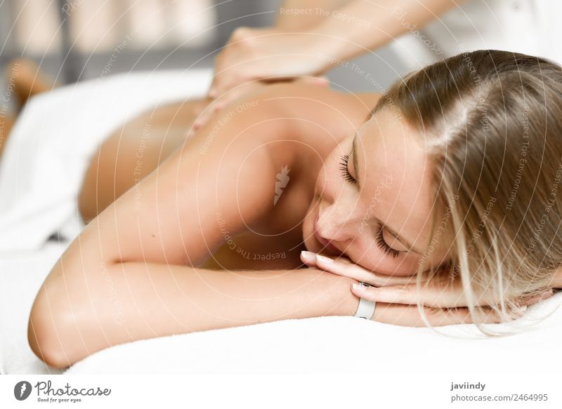 Young blond woman having massage in the spa salon Lifestyle Beautiful Body Health care Wellness Relaxation Spa Massage Human being Young woman