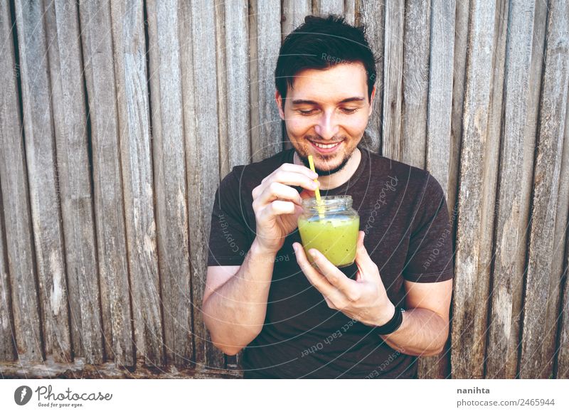 Young happy man enjoying a green smoothie - a Royalty Free Stock Photo from  Photocase