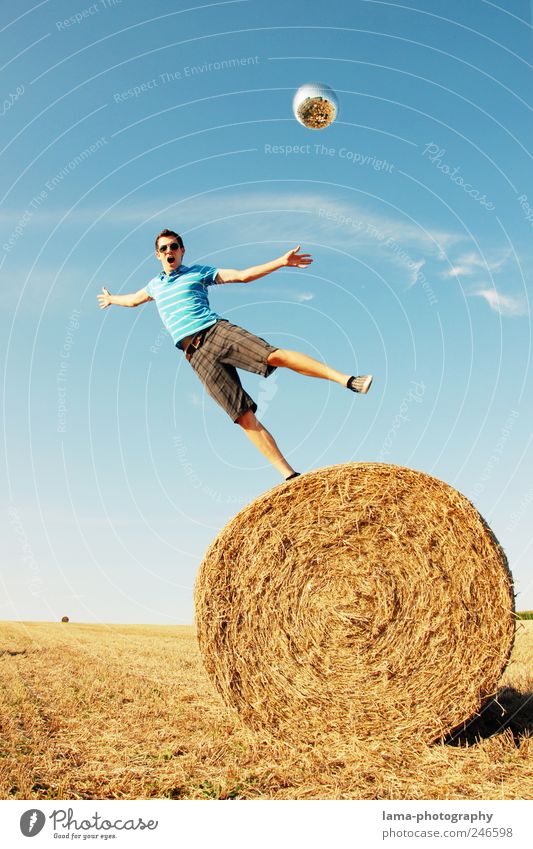GRAVITY Joy Human being Masculine Young man Youth (Young adults) 1 18 - 30 years Adults Cloudless sky Sunlight Summer Field Bale of straw To fall Flying Playing