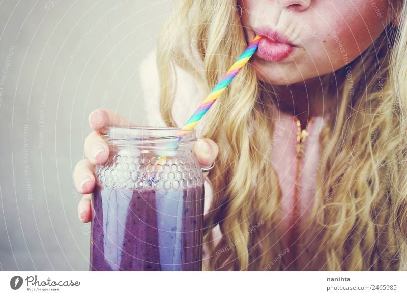 Close up of a young woman drinking a smoothie Fruit Berries Straw Beverage Drinking Cold drink Juice Milk Milkshake Bottle Lifestyle Style Healthy Eating