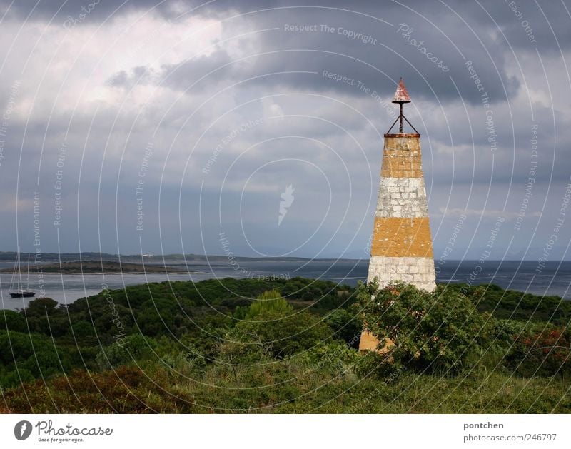 Lighthouse in front of the sea in cloudy weather. Vacation & Travel Trip Sailing Nature Landscape Elements Sky Clouds Storm clouds Weather Bad weather bushes