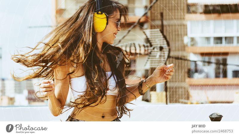 cheerful woman with long hair on headphones listens to music Lifestyle Style Joy Happy Beautiful Freedom Summer Music Dance Telephone Headset Human being Woman