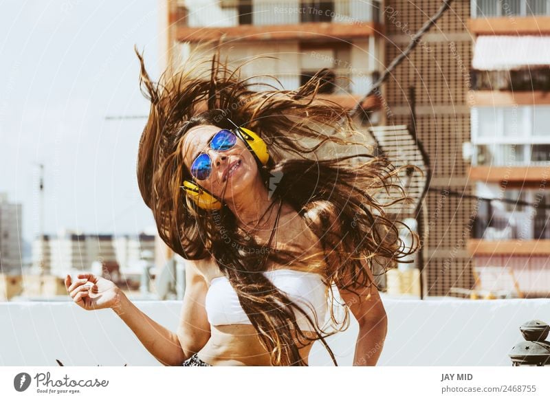 cheerful woman with long hairand and headphones, dances Lifestyle Style Joy Happy Beautiful Freedom Summer Music Dance Telephone Headset Human being Woman