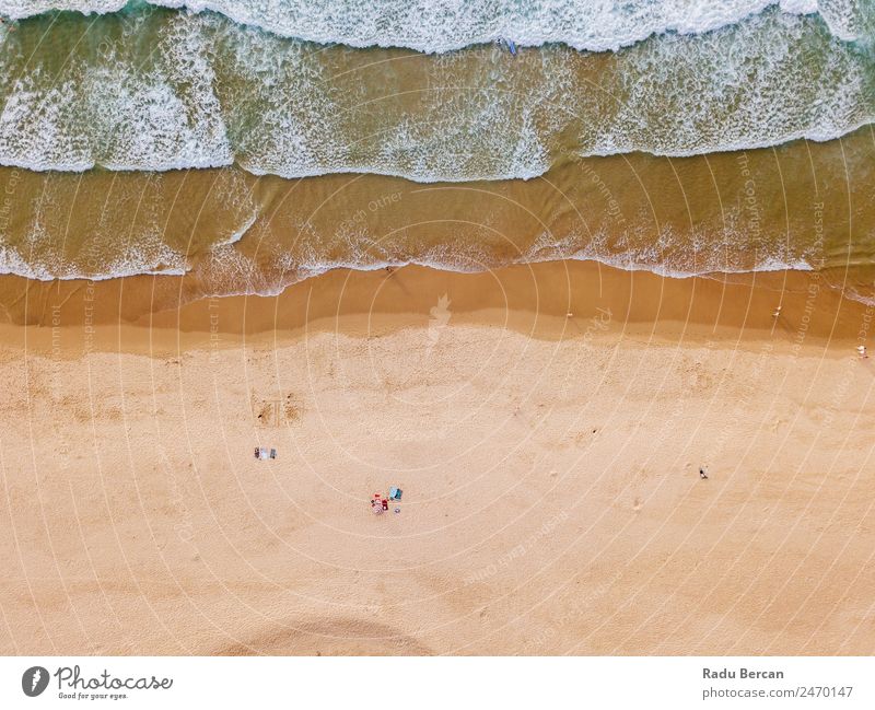 Aerial View From Flying Drone Of People Crowd Relaxing On Algarve Beach In Portugal Aircraft Vantage point Sand Background picture Water Above Ocean