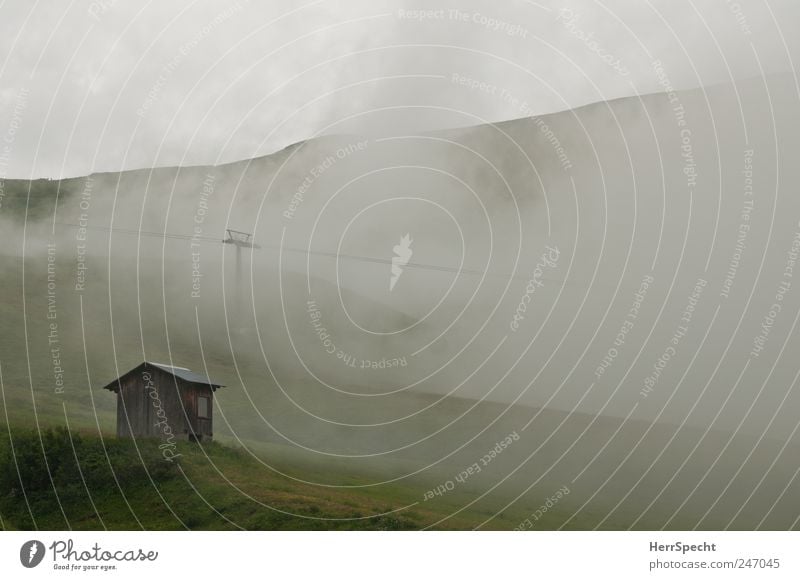 hut weather Environment Nature Landscape Bad weather Fog Alps Mountain Hut Threat Cold Gray Green Loneliness Apocalyptic sentiment Alpine pasture Cable car Hill