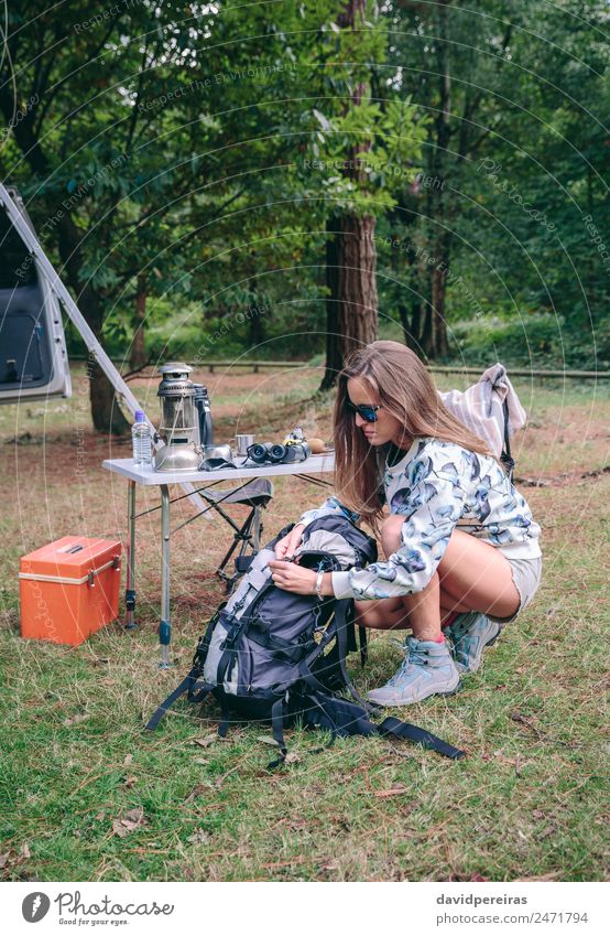Woman preparing backpack for a hiking trip Lifestyle Joy Happy Leisure and hobbies Vacation & Travel Trip Adventure Camping Summer Mountain Hiking Sports