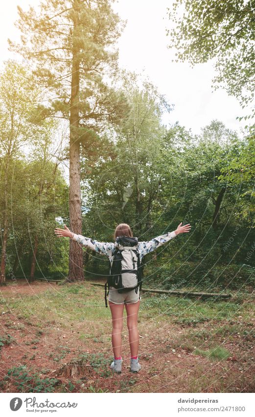 Hiker woman with backpack raising her arms into the forest Lifestyle Joy Happy Relaxation Leisure and hobbies Vacation & Travel Trip Adventure Freedom Summer