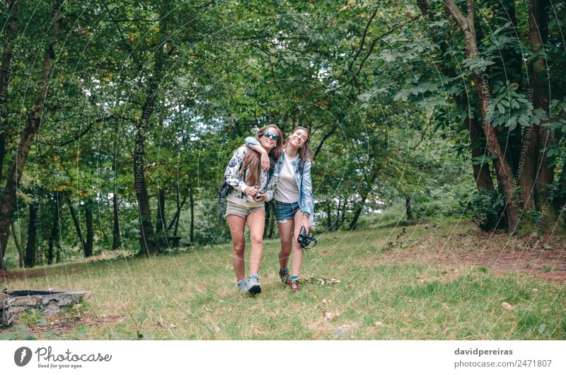 Women friends laughing while walking in forest Lifestyle Joy Happy Relaxation Vacation & Travel Trip Adventure Camping Summer Mountain Hiking Sports Camera